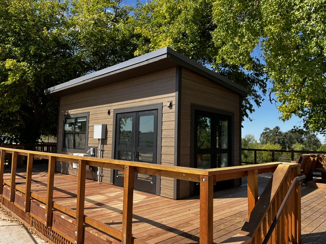 Custom modular building at Dos Rios State Park with glass double doors and a shed-style roof
